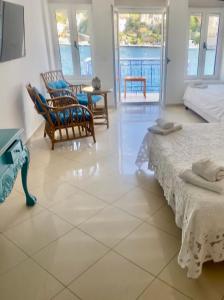 a bedroom with two beds and a view of the ocean at Cavo apartment in Symi