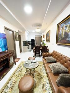 a living room with a couch and a tv at Ductaigallery's Apt& Pool-Good view in Ấp Phú Thọ