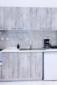 a kitchen with a sink and a coffee maker at Lux studio at French Institute in Thessaloniki