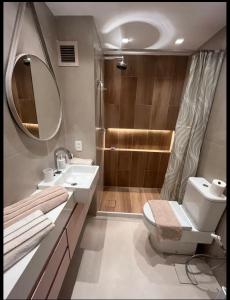 a bathroom with a toilet and a sink and a shower at Apart hotel plaza Elysées in Rio de Janeiro