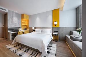 Qingdao Oriental Studio Chuangzhi SSAW Hotel 객실 침대