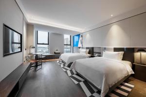 Qingdao Oriental Studio Chuangzhi SSAW Hotel 객실 침대
