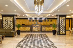 a lobby of a hotel with a chandelier at Wyndham Baku in Baku