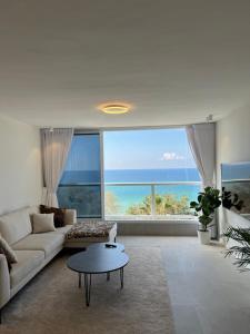 a living room with a view of the ocean at Vacation Apartment By The Beach in Bat Yam