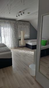 a large room with two beds and a mirror at Gästehaus Yvonne Sigg in Rust