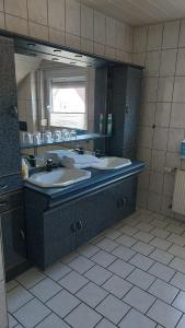 a bathroom with two sinks and a large mirror at Gästehaus Yvonne Sigg in Rust