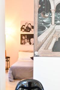 a bedroom with a bed and a picture of a city at Camere D'artista in Enna