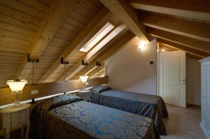 a bedroom with two beds in a room with wooden ceilings at Cadifiore B&B in Mira +36 photos