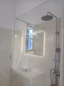 a bathroom with a sink and a mirror at Kalymnos, très belle villa avec vue sur la mer in Kalymnos