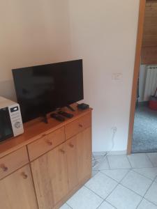 a flat screen tv sitting on top of a wooden cabinet at Apartment Zorc in Trenta