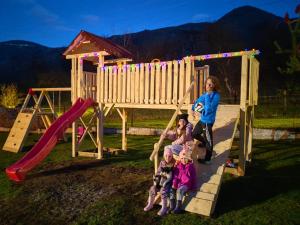 a group of children playing on a playground at Cabana Valea Sadului in Rau Sadului