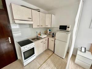 a small kitchen with a white stove and refrigerator at Apartment TiSa, Bovec in Bovec