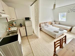 a kitchen and a living room with a bed in a room at Apartment TiSa, Bovec in Bovec