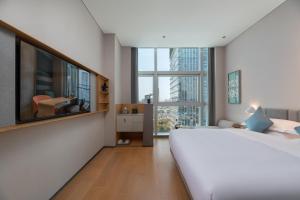 Postel nebo postele na pokoji v ubytování Pagoda Hotel Shenzhen + 37 fotografií