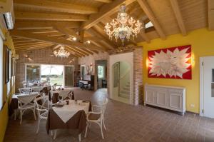 a dining room with tables and chairs and a chandelier at Cadifiore B&B in Mira
