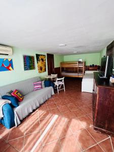 a living room with a couch and a television at Casa Rural Serafïn, Pet Friendly in Renera