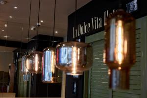 a row of lights hanging from the ceiling in a store at Hotel GIO in Munich