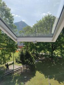 a large window in a building with a garden at Apartment TiSa, Bovec in Bovec