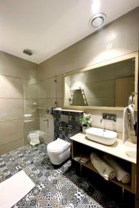 a bathroom with a toilet and a sink and a mirror at Hotel Classic Residency in Kālka