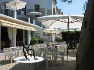 a statue of a man on a table in front of a building at Hotel Pierre Loti in Juan-les-Pins