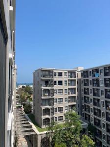 a tall apartment building with a blue sky in the background at Lacasita Near Beach Huahin (Room652) in Hua Hin