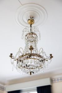 a chandelier hanging from a ceiling at Park Hotel Linköping Fawlty Towers in Linköping