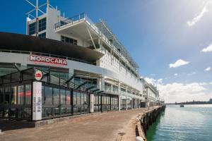 a large building next to a body of water at Luxury Apartment - Parking - Hot Tub - Stunning Views in Auckland
