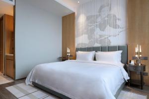 Qingdao Oriental Studio Chuangzhi SSAW Hotel 객실 침대