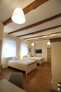 a large bedroom with two beds and a table at Pension Alte Scheune in Melsungen
