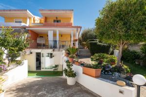 a house with potted plants on the side of it at Villetta Capitana Vista Mare in Capitana