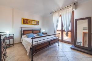 a bedroom with a bed and a mirror in it at Villetta Capitana Vista Mare in Capitana