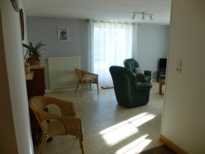 a living room with two chairs and a couch at Gîte de says in Champagné-Saint-Hilaire