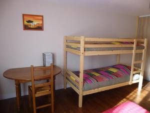 a bedroom with a bunk bed and a table at Gîte de says in Champagné-Saint-Hilaire