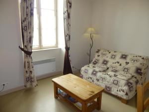 a bedroom with a bed and a table and a window at Les noisettes in Lhommaizé