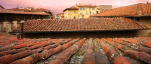 a group of red roofs with buildings in the background at HomEdoApartments Deluxe Terme suite in Florence