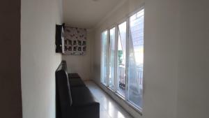 a living room with a couch and a window at Superstar Residence Tomohon Redpartner in Tomohon
