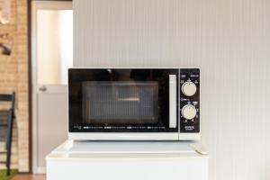 a microwave oven sitting on top of a counter at Heights MR2 - Vacation STAY 88275 in Nara