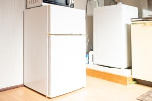 a white refrigerator in a kitchen next to two refrigerators at Heights MR2 - Vacation STAY 88275 in Nara