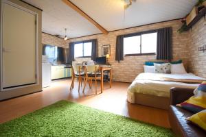 a bedroom with a bed and a table with a green rug at Heights MR2 - Vacation STAY 88275 in Nara
