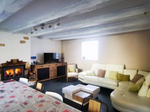 a living room with a couch and a table at Maison Aulon (Saint Lary) in Aulon