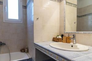 a bathroom with a sink and a tub and a mirror at Sea View Villa-Luxury Residence-Nature & Calm in Porto Heli