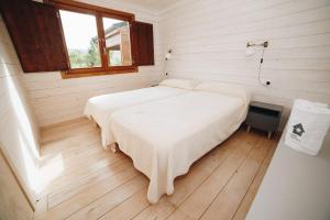 a bedroom with two beds in a room with a window at Vall d'Àger Resort & Camping in Ager