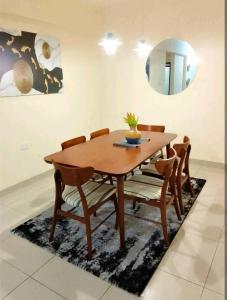 a dining room table with chairs and a mirror at MEDZAM HOMES BRILLIANT THREE BEDROOM ALL WITH OCEAN ViEW in Mombasa