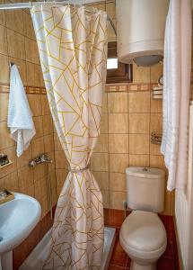 a bathroom with a toilet and a sink at Stamoulis' house in Drakeia