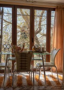 a dining room with a glass table and chairs at Stamoulis' house in Drakeia