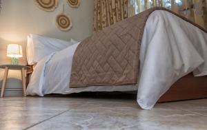 a bed with a blanket on the floor in a room at Stamoulis' house in Drakeia +13 photos