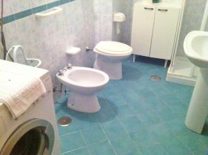 a bathroom with a toilet and a sink at Villa delle Muse da Imma in Palinuro