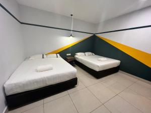 Postel nebo postele na pokoji v ubytování Smile Hotel Klang Bukit Tinggi