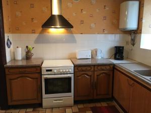 a kitchen with a stove and a sink in it at R-d-t in Martaizé