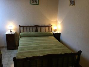 a bedroom with a bed and two lamps on tables at R-d-t in Martaizé